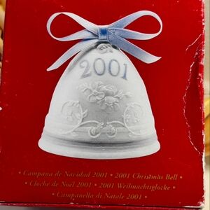 2001 Lladro Christmas bell measuring at 3" x 3" x 3". White with 2001 in blue.